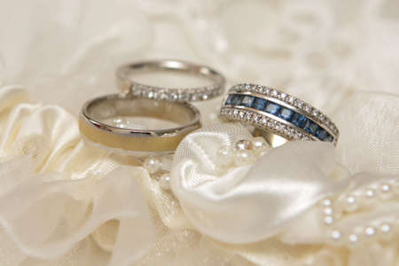 Three wedding rings with diamonds and gems の写真素材