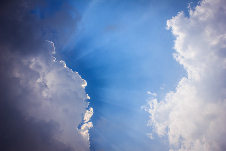 light from the sun shining through the cloudの写真素材