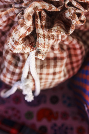 brown plaid fabric bag with white stringの写真素材