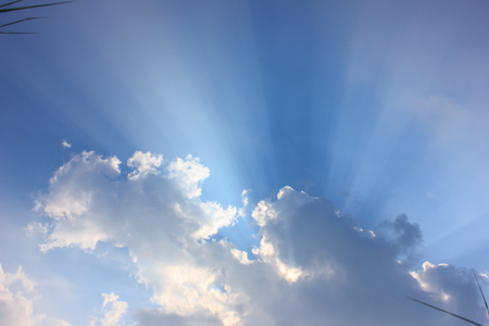 light from the sun pass through cloudsの写真素材