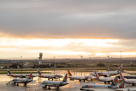 Melbourne Tullamarine airport with Virgin, Jetstar and Tiger aeroplanes grounded on the tarmac during the Corona COVID-10 pandemic, the air traffic control tower is in the back groundのeditorial素材