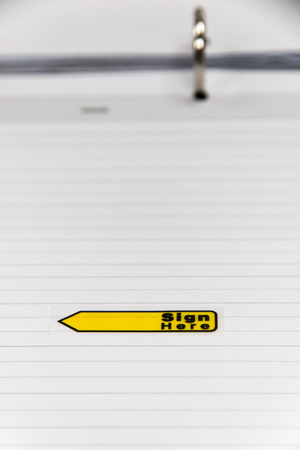 yellow sticker sign here on table  scheduleの写真素材