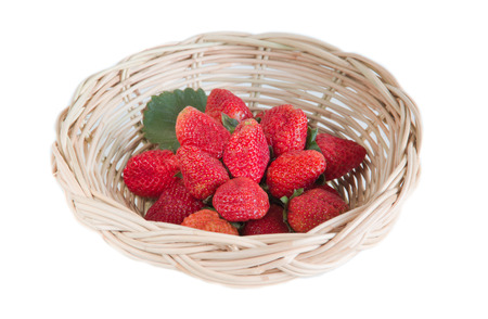 Strawberries and leaf in basket on a white backgroundの写真素材