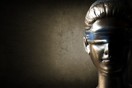 Face of Lady Justice in dark brown backgroundの写真素材