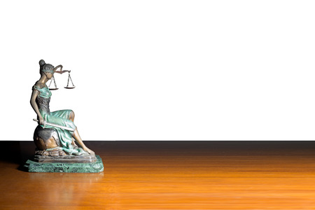 Lady justice or Themis on wooden table isolated on white backgroundの写真素材