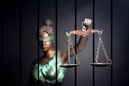 Lady Justice against jail backgroundの写真素材
