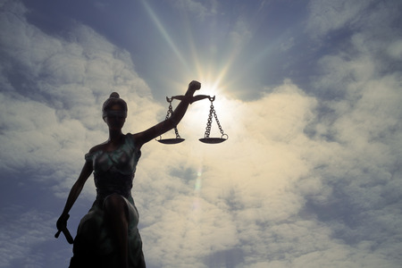 Silhouette of Lady of Justice and light of Godの写真素材