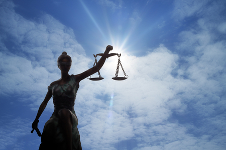 Silhouette of Lady of Justice and light of Godの写真素材
