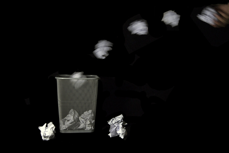 Throwing crumpled paper to trashの写真素材
