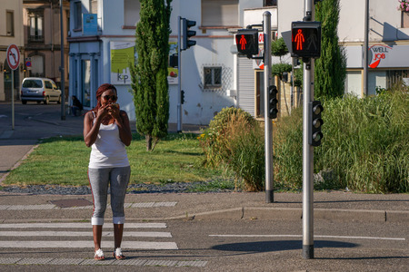 Colmar, Alsace, France- July 26, 2018 :  Woman stop walking at a red light signのeditorial素材