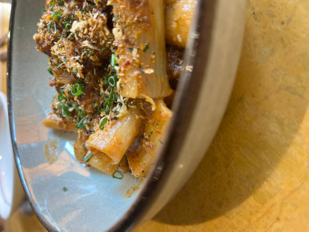 Cannelloni pasta in a bowl on a wooden table.の写真素材