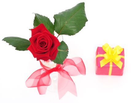 Red rose in vase and a giftの写真素材