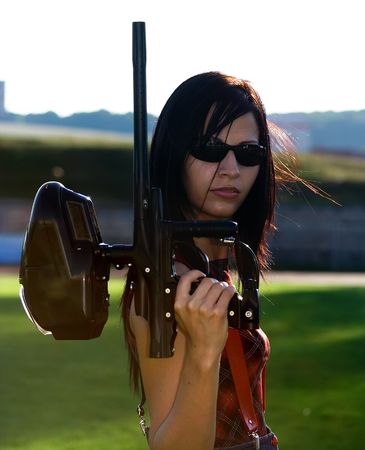 Female paintball player holding the markerの写真素材