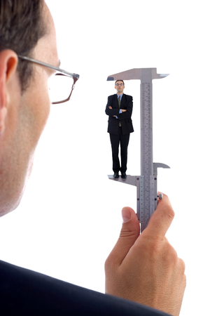 Measuring a men. Metaphoric view of a test before employmentの写真素材