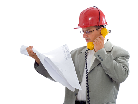 Construction engineer talking on phone about details of the projectの写真素材