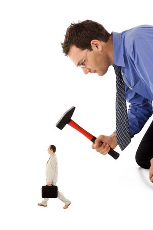 Businessman unfairly eliminating a small, rival colleagueの写真素材