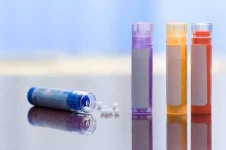 Close view of homeopathic medications - containers and small white ballsの写真素材