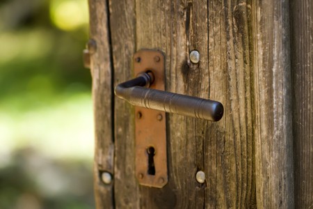 Old wooden door with rusty iron handleの写真素材