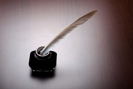 Old writing method: bottle of ink and feather 