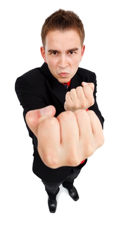 Wide angle view of an aggressive young man, showing fist, he wants to fightの写真素材