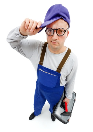 Wide angle view of an awkward repairman with hammer and toolboxの写真素材