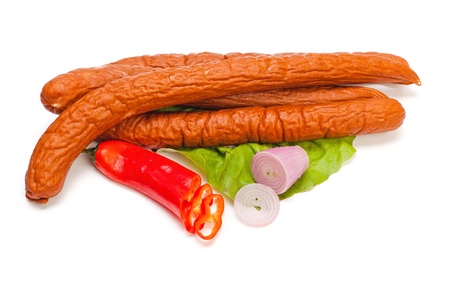 Turkey sausages on lettuce, pepper and onion decorationの写真素材