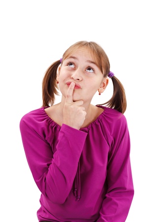 Teenager girl thinking, holding finger at mouth and looking up to copy spaceの写真素材