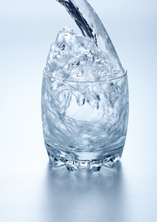 Water flowing into a glassの写真素材