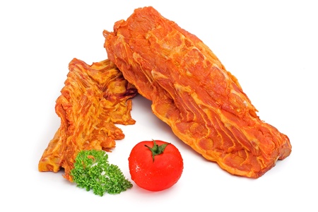 Spicy pork loin rack joint with tomato and parsley decorationの写真素材