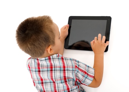 Top view of a little boy playing on tablet PCの写真素材