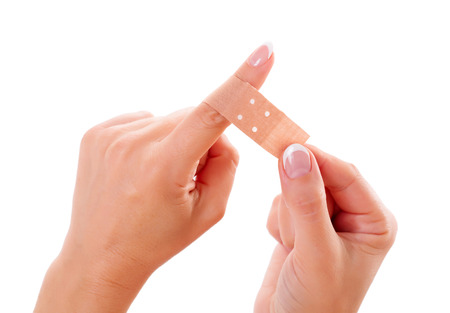 Wounded woman finger bandaged with plaster
