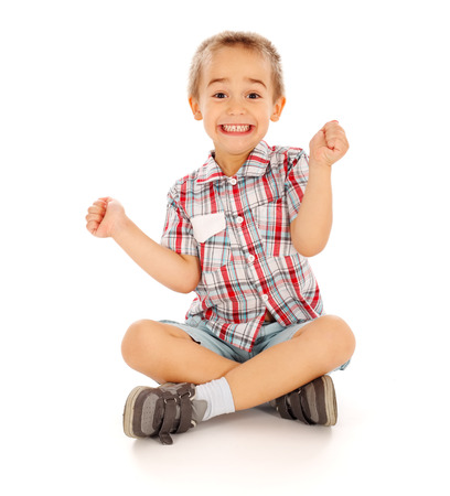 Very excited little guy sitting and cheeringの写真素材