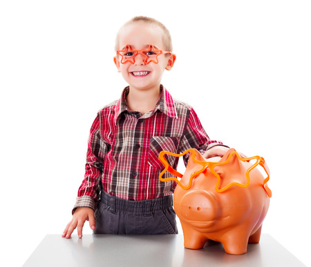 Smiling little child taking care of his saved moneyの写真素材