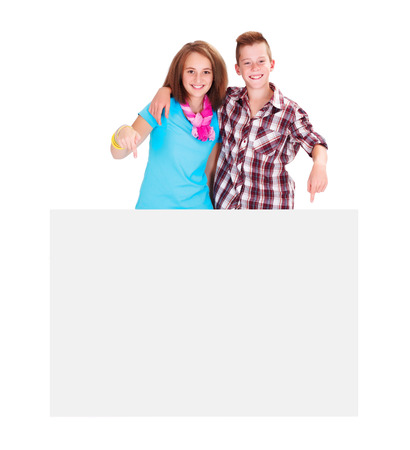 Young teenagers showing white blank billboardの写真素材