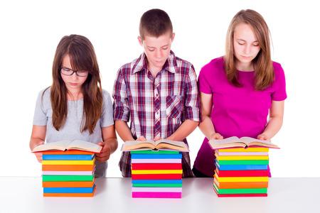 School girls and boy reading and learning from booksの写真素材