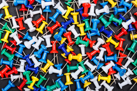 Colorful plastic push pins on black backgroundの写真素材