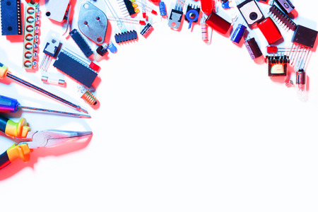 Copy space surrounded by electric components and tools in red and blue light