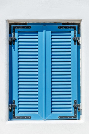 Closed blue window with Bahama shuttersの写真素材