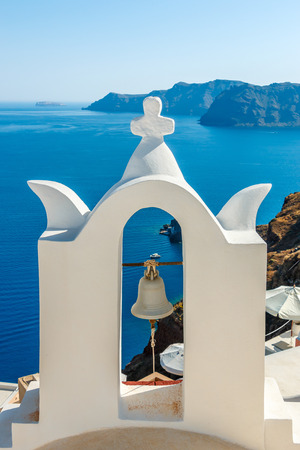 Bell tower near the sea in Oia town, Santorini island, Greeceの写真素材