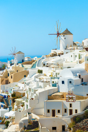 Windmills and buildings on the hill in the famous Oia town, Santorini island, Greeceのeditorial素材
