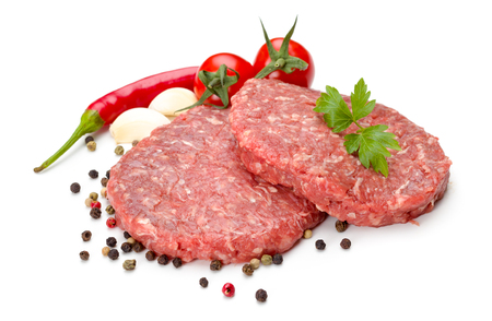 Uncooked beef hamburger meat on white with pepper seedsの写真素材