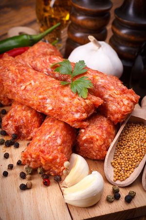 Closeup of romanian pork and lamb sausages, mititei with pepper and garlicの写真素材