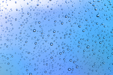 Tiny water drops on blue backgroundの写真素材