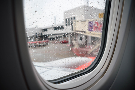 Inside a plane park in airport, Raindrop on the window, Selective focus. Sad