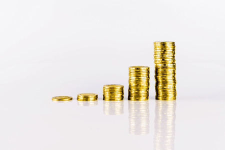 Gold Coin Growth Graph on White Background with Reflextionの写真素材