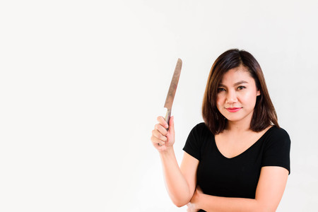 Asian Woman with a Knife in her Hand on White Background