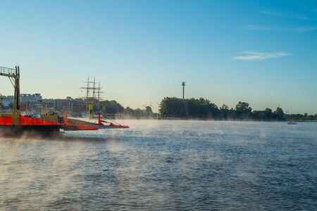 In the early morning, a light fog settles on the river Weser in Bremen