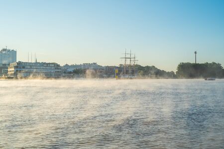In the early morning, a light fog settles on the river Weser in Bremen