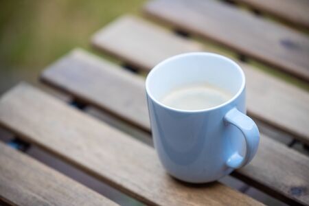 sitting in the garden early in the morning with a hot cup of  coffeeの写真素材