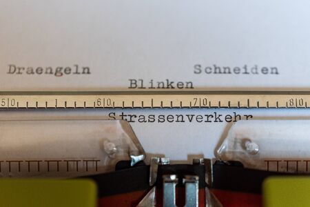 Typewriter with a leaf and the words Draengeln, Schneiden, Blinken und Strassenverkehr  (Draining,...